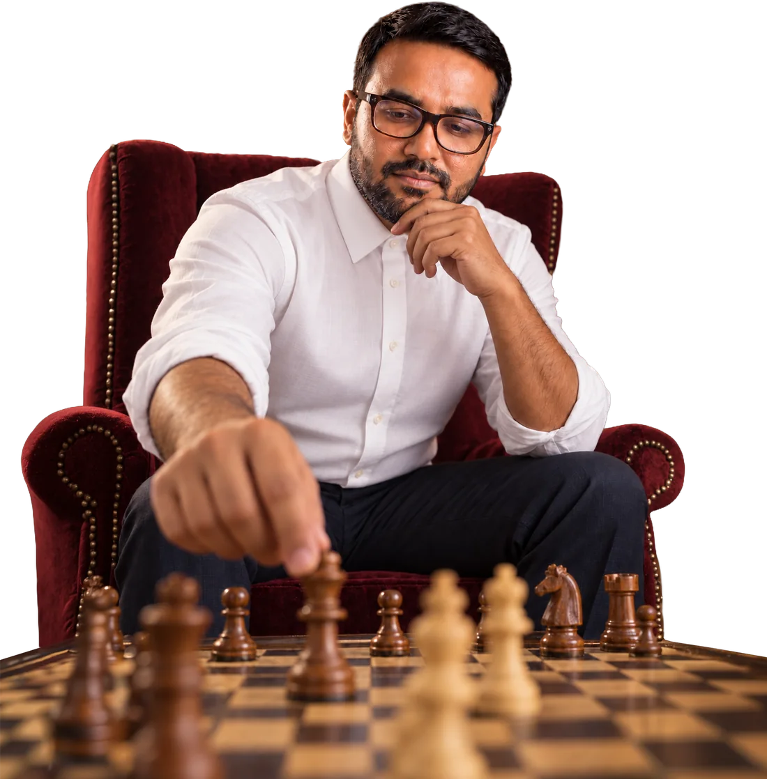 Alif Meherab in a red armchair, thinking over his next move on a chessboard